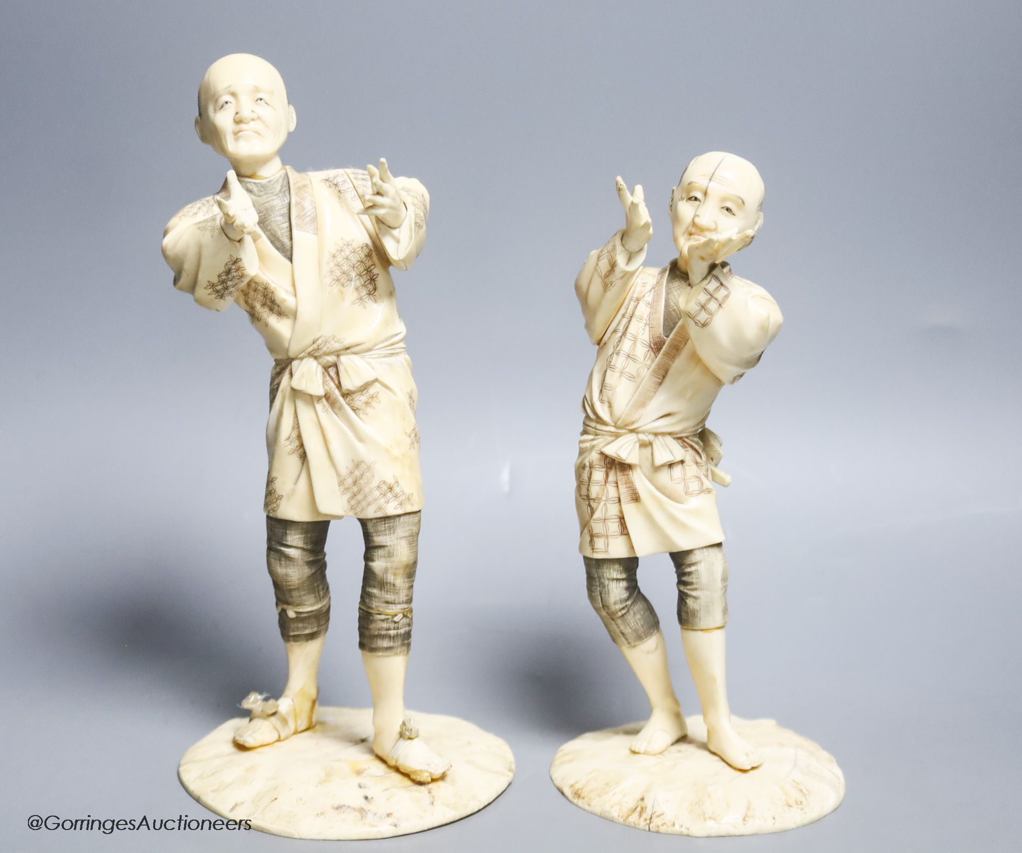 Two Japanese sectional ivory figures of farmers, early 20th century, one signed to base, height 24cm